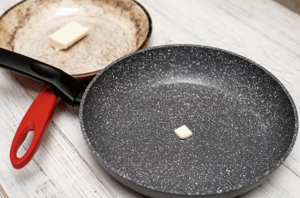 a granite pan next to another pan