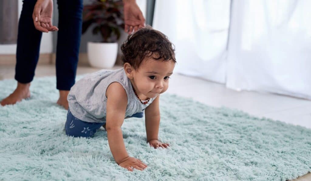 a young child crawling on the floor