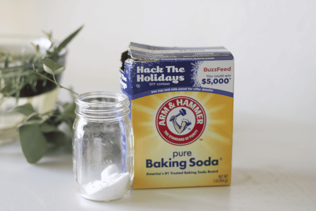 arm and hammer baking soda next to a glass jar