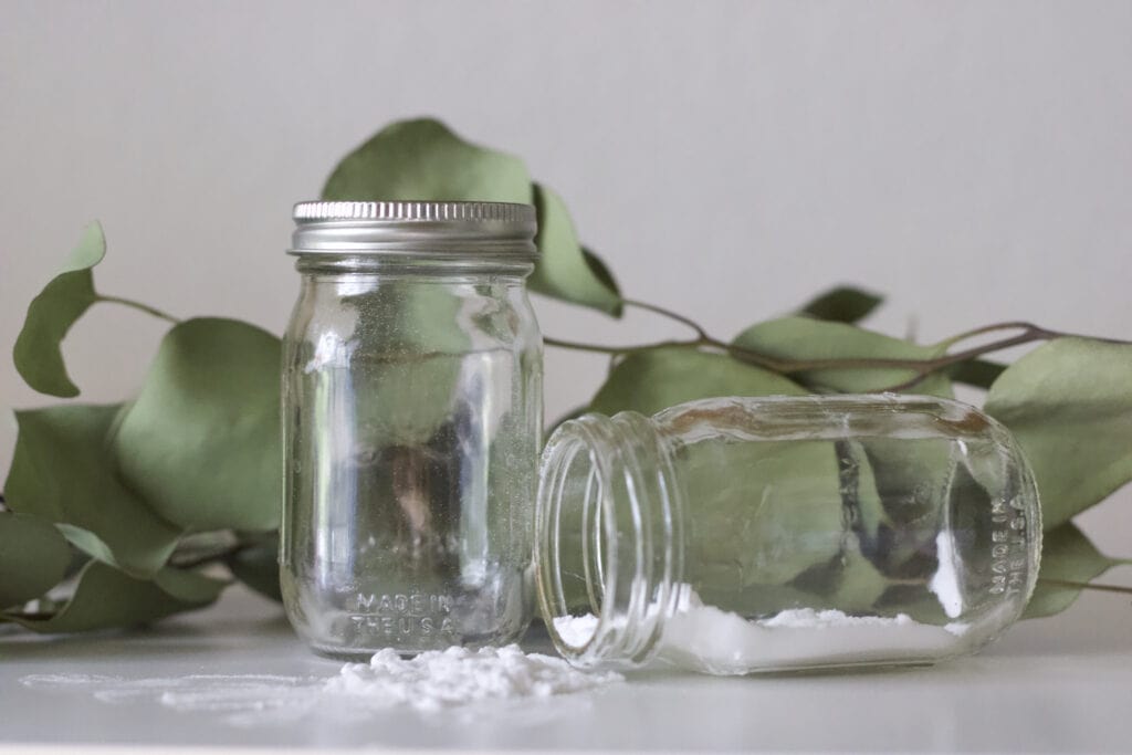 two mason jars with a cleaning mixture in them