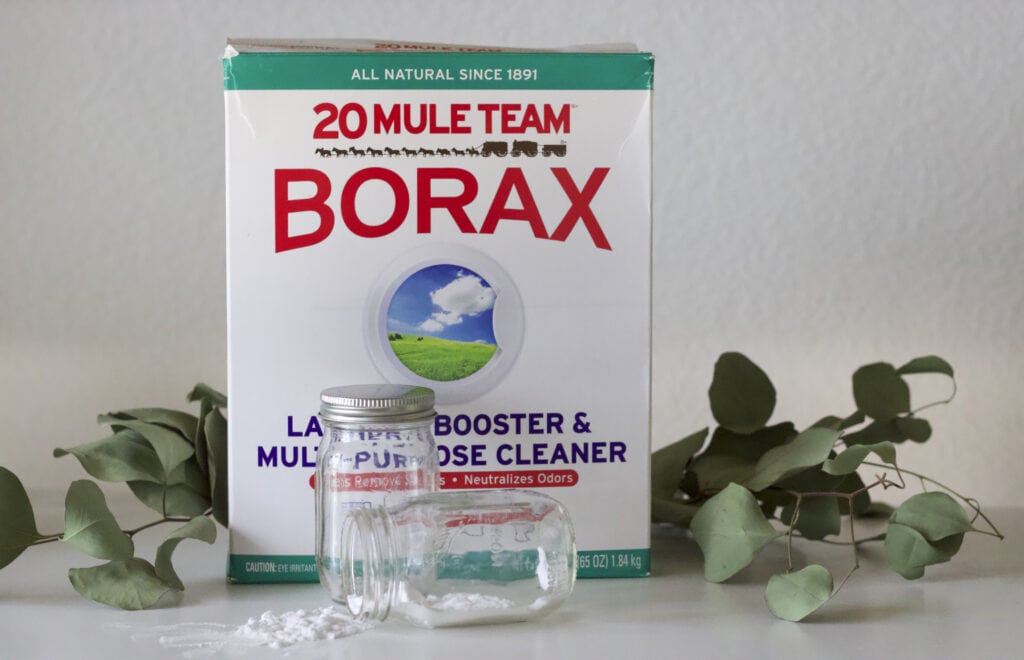 a box of borax next to a glass jar