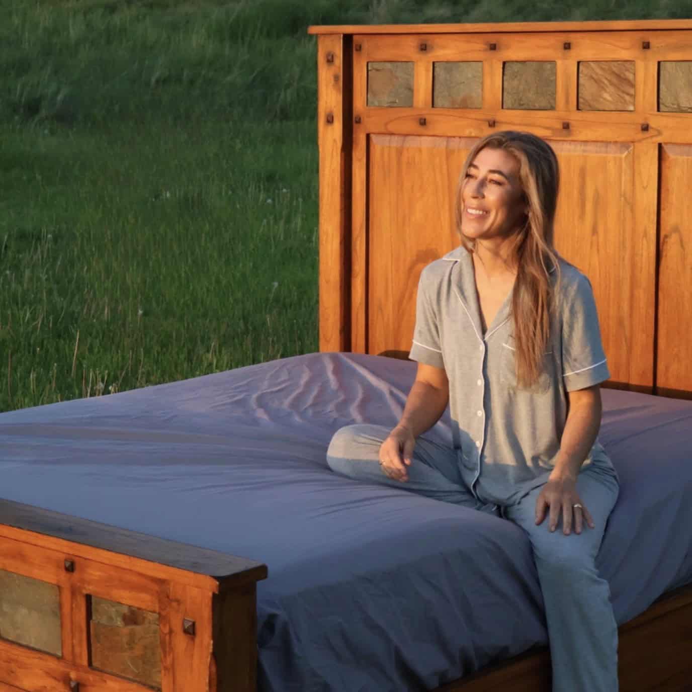 a woman sitting on a bed