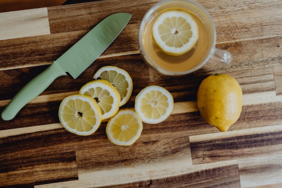 sliced lemons on a wooden cutting board