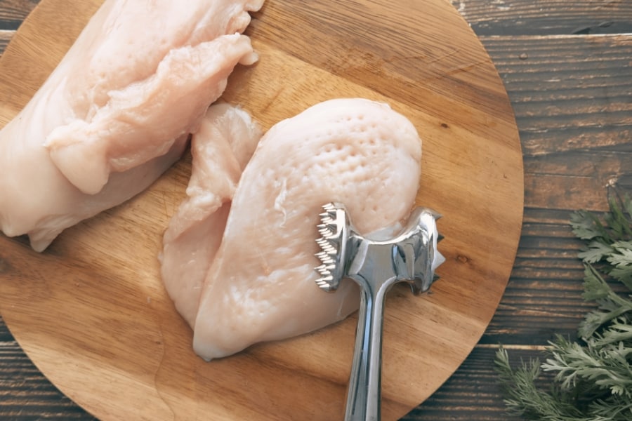 raw chicken on a wood cutting board