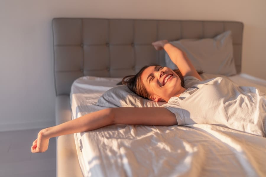 a lady stretching in bed