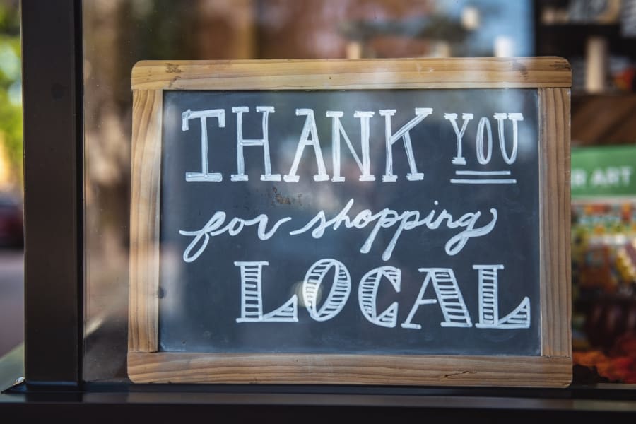 Sign in a window saying thank you for shopping local