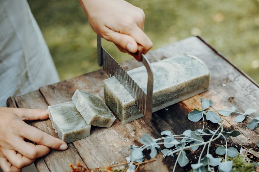 person making their own homemade soap