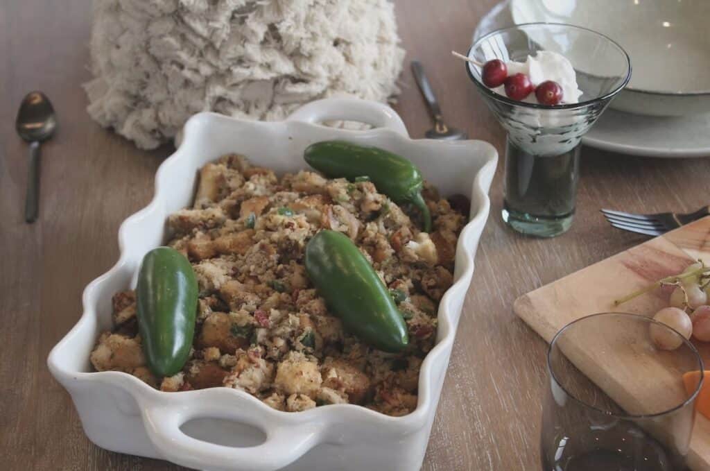 a white ceramic bakeware dish with stuffing inside of it
