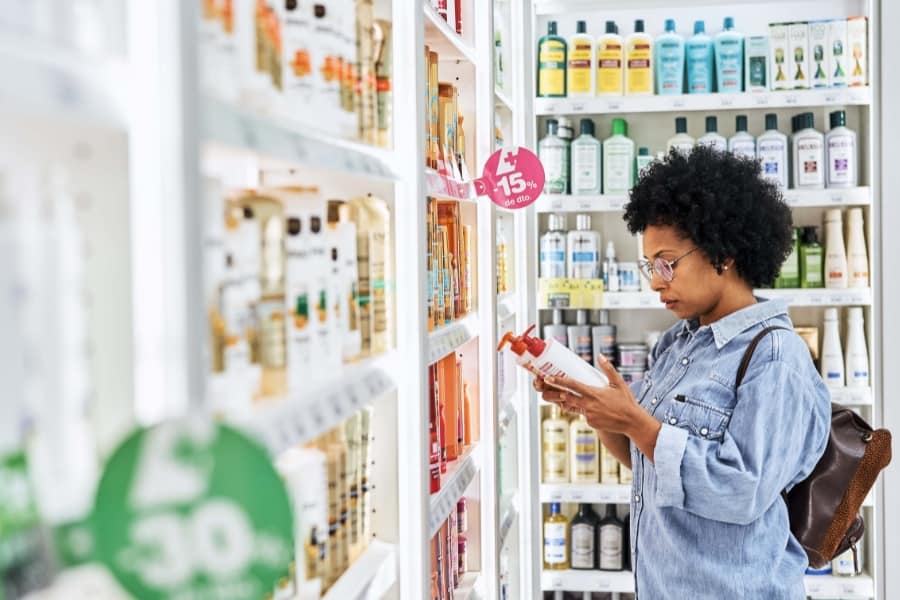 a person reading a lotion label in a store