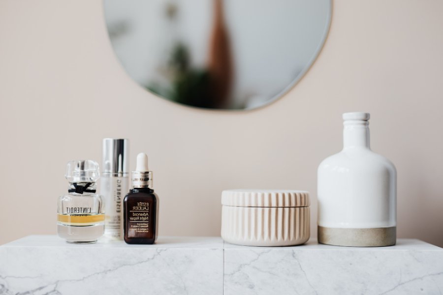 perfume and other fragranced personal care products sitting on a bathroom counter