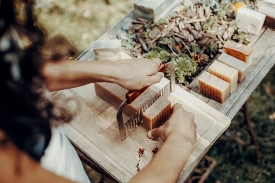 picture of a soap artisan hand making bars of soaps