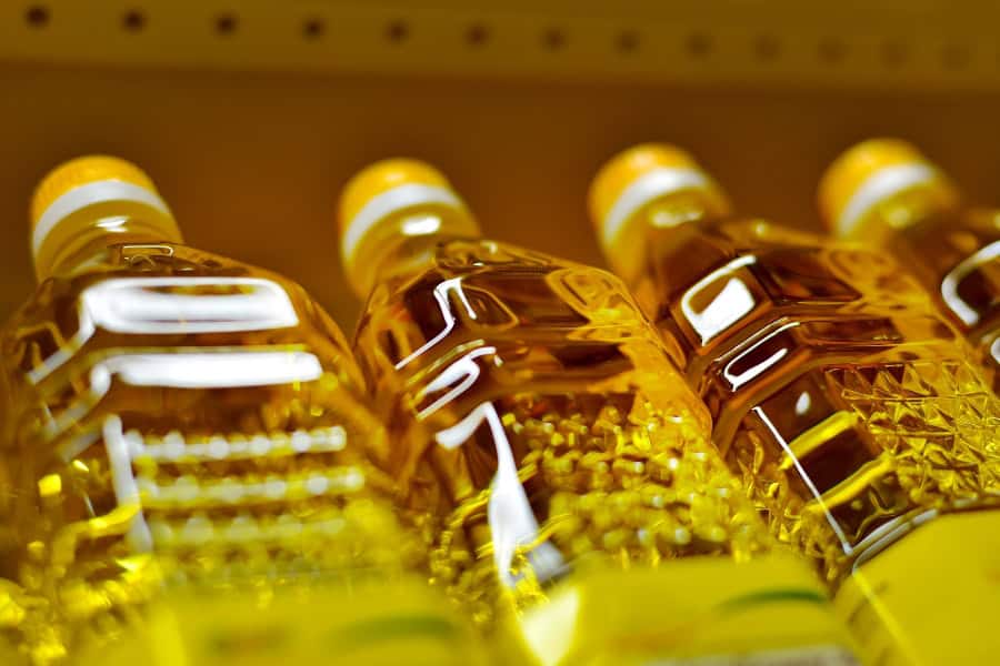 plastic jars of seed oils on a store shelf