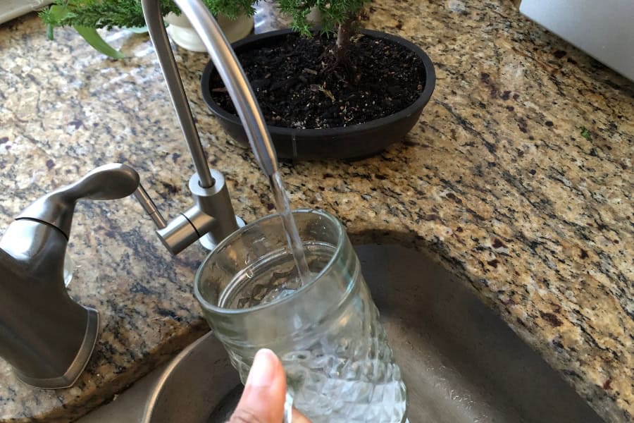 picture of me filling up a glass with water from a water filter