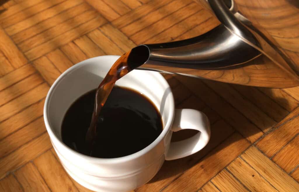 cup of coffee being poured