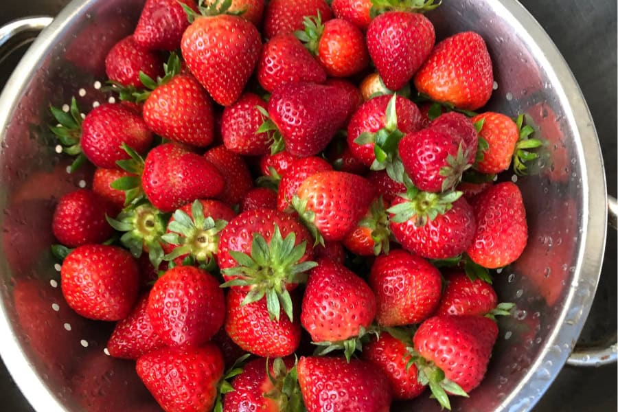 Strawberries being washed in a bowl 