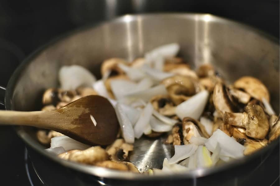 mushroom and onions cooking in a pot 