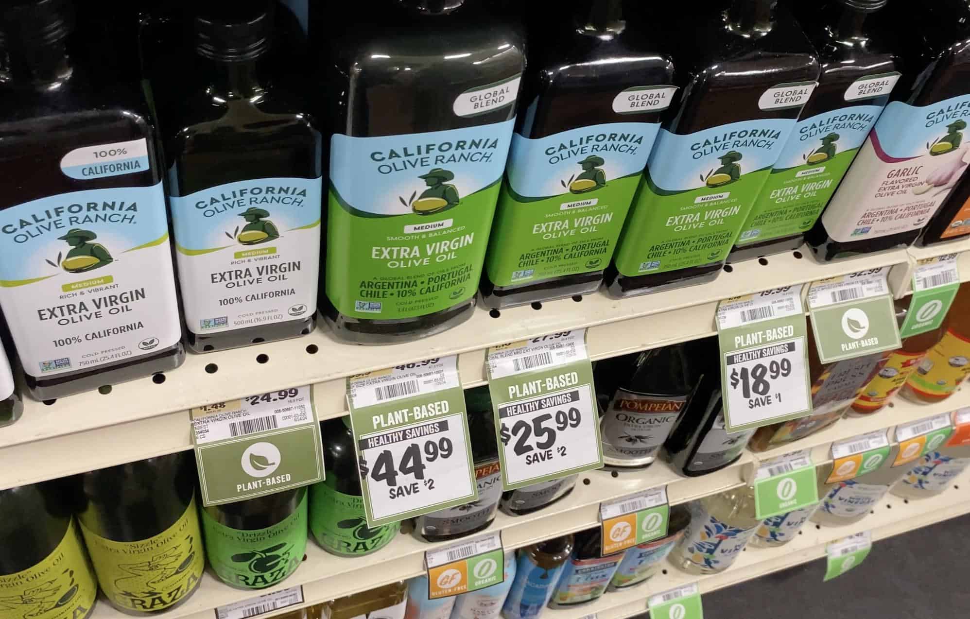 olive oils on a grocery store shelf showing the prices