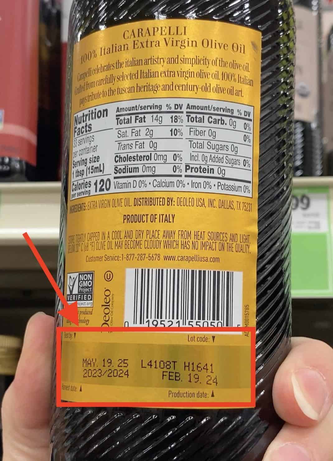 a harvest date label on the bottom of a olive oil bottle