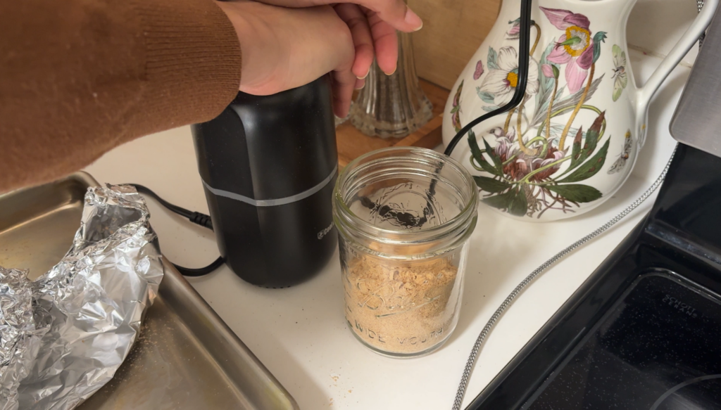 blending baked almond pulp in a coffee grinder