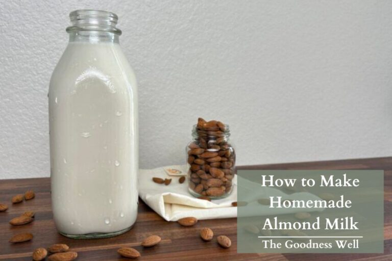 homemade almond milk with a jar of almonds in the background