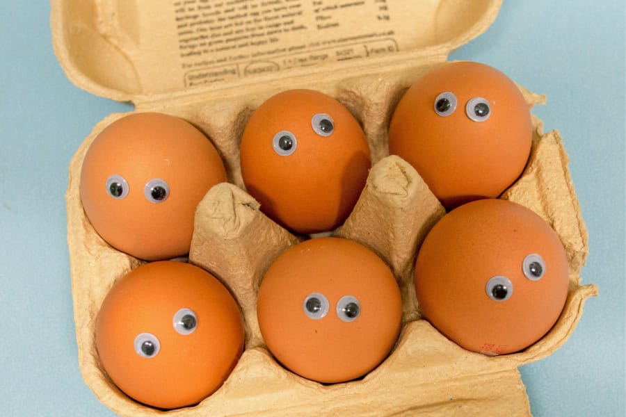 eggs in a carton with googly eyes