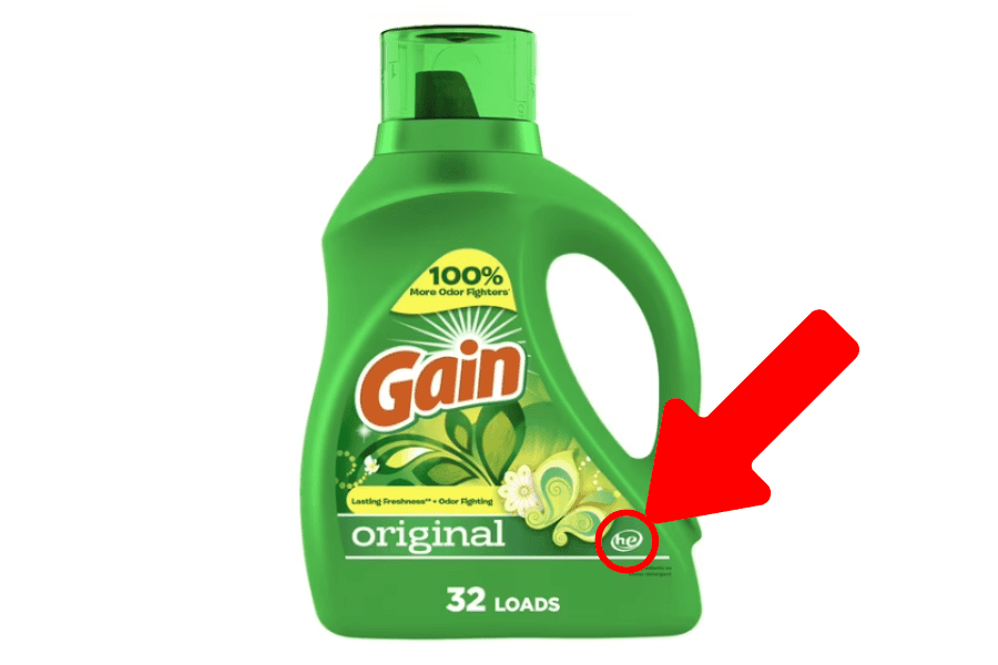 pointing and circling the HE (high efficiency) logo on a detergent bottle