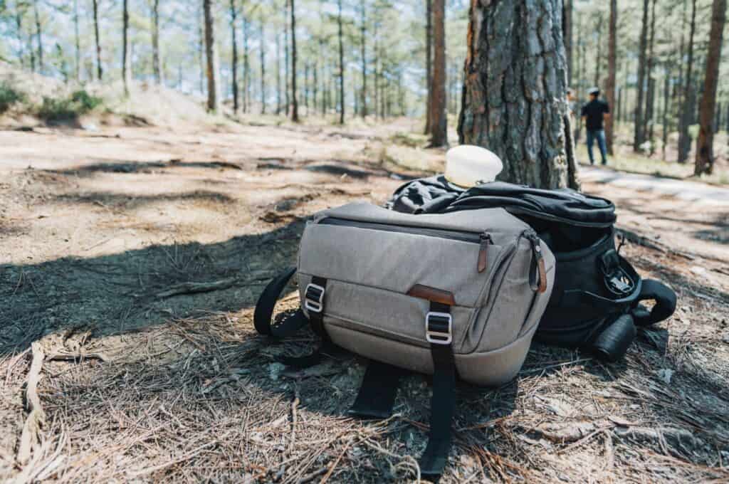 a cotton duffel bag sitting near a tree outdoors