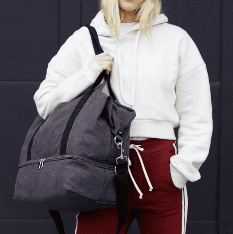 a woman holding a gym bag