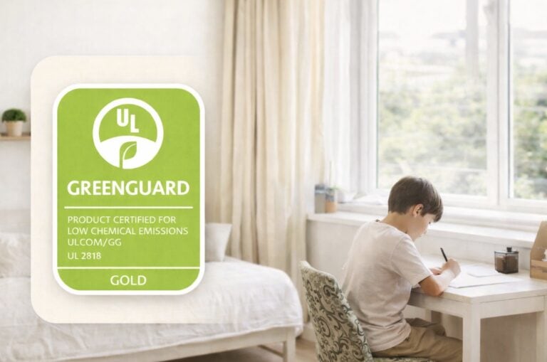 GREENGUARD Gold Certified logo next to a child working at a desk in a bright bedroom.