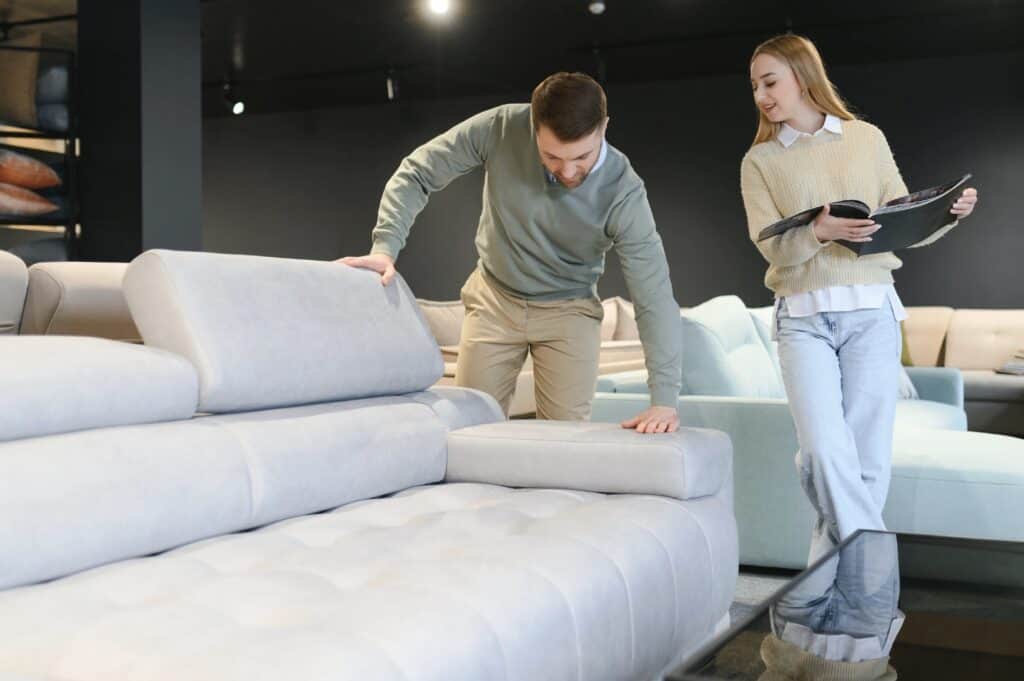 A shopper examining a mattress or couch in a store