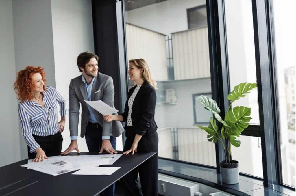 Business team reviewing printed documents around a meeting table
