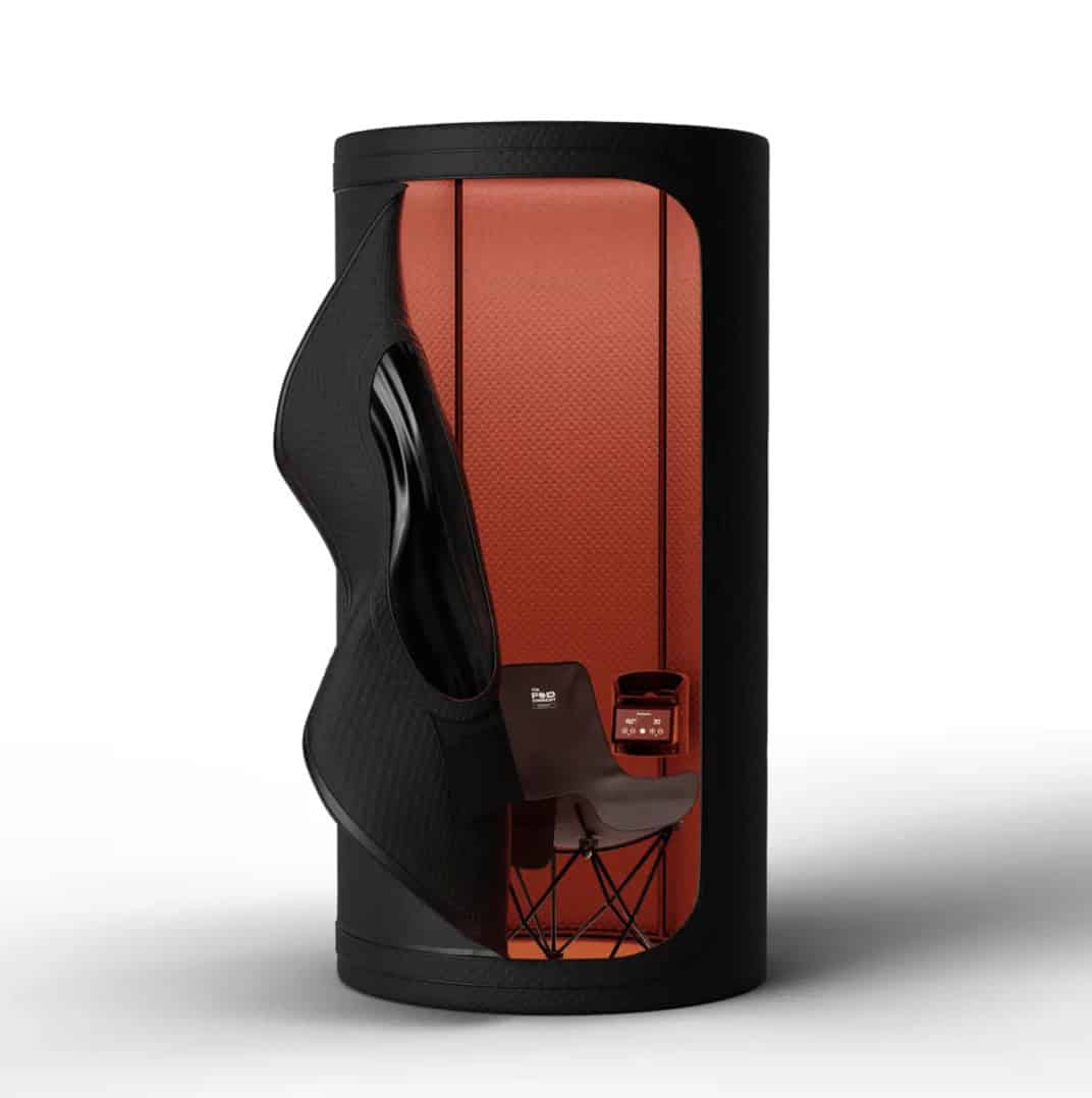 Compact portable infrared sauna pod with cylindrical design, seated interior, and red heat panels