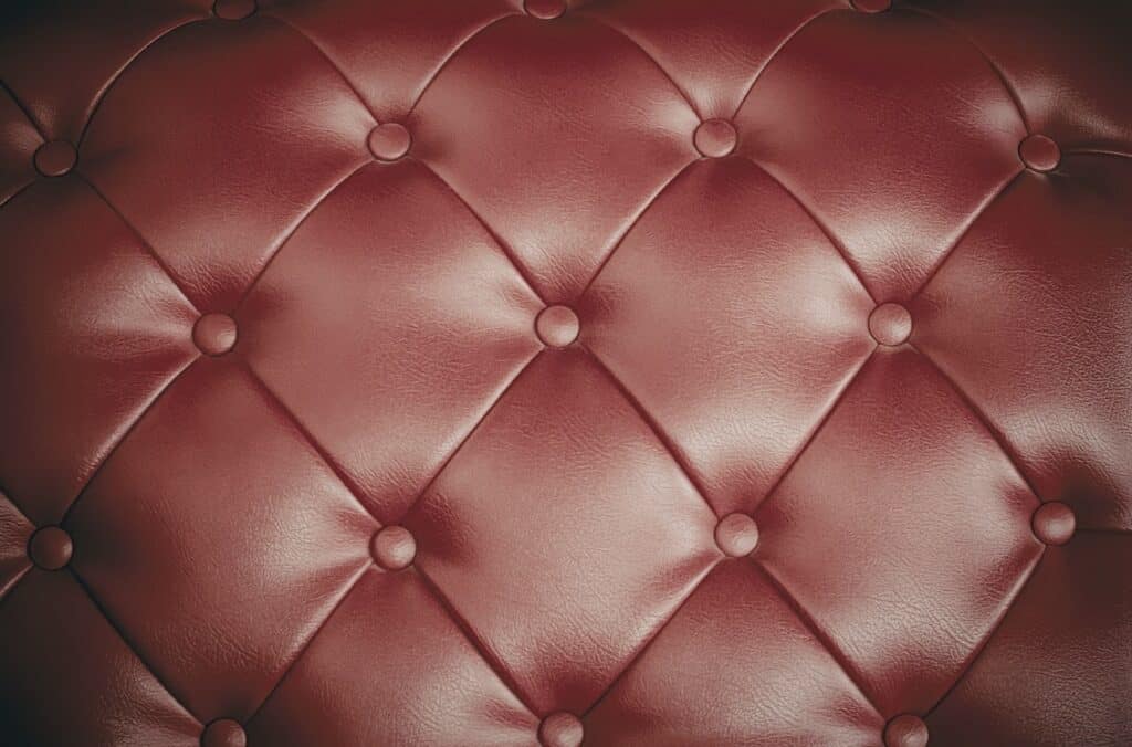 Close-up of red tufted leather upholstery 