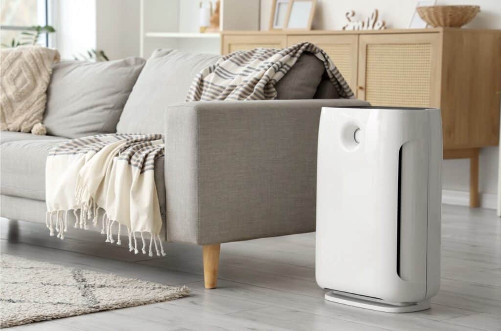 Air purifier next to a couch in a normal living room