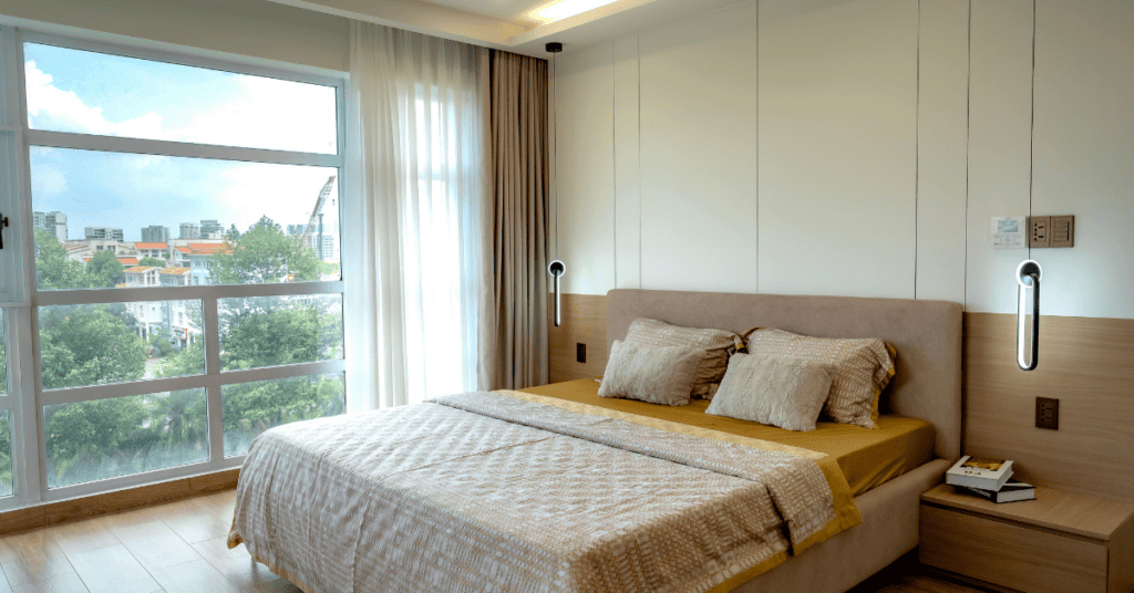 clean modern bedroom with a bed placed near a large window