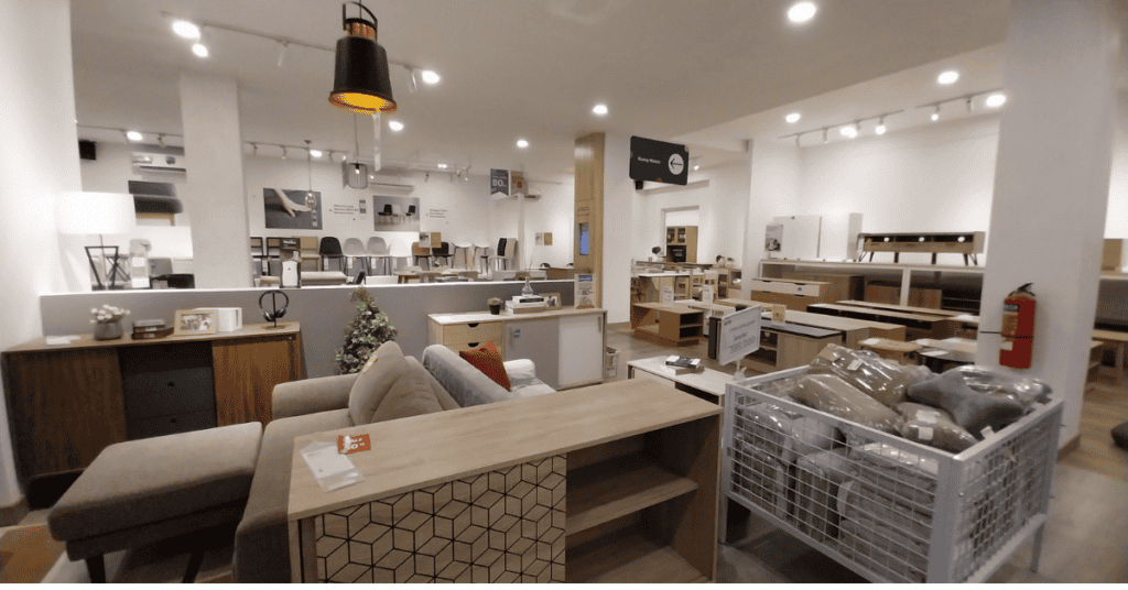 Furniture showroom with dressers, couches, tables, and home decor on display.