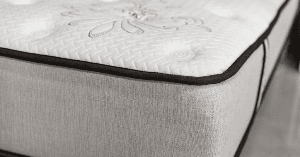 close-up of mattress side fabric, edge stitching, and top cover texture