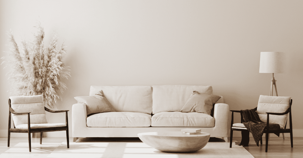 Neutral living room with a cream sofa, chairs, and natural decor