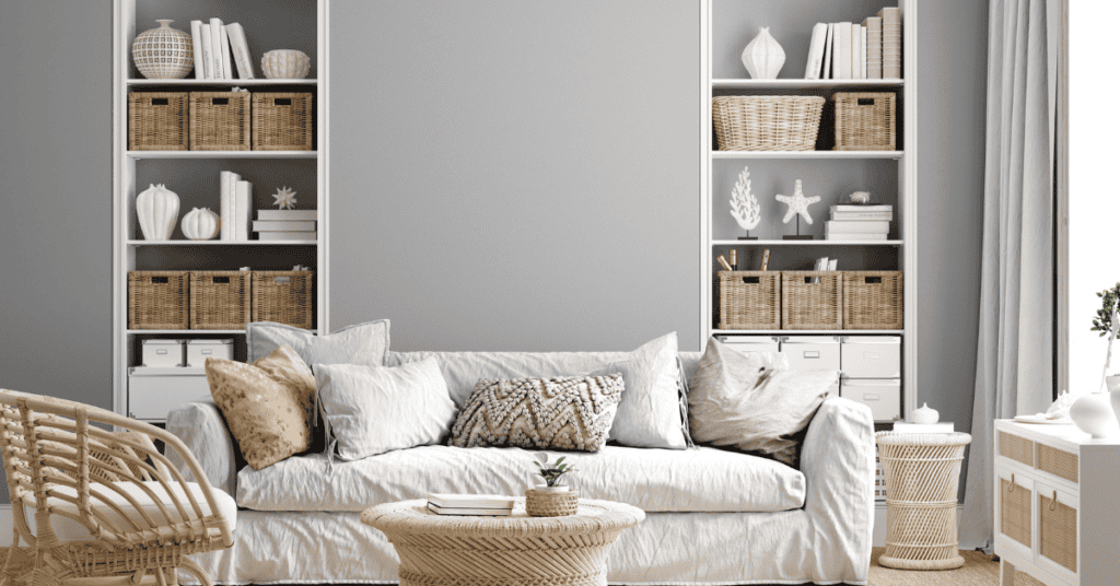 Neutral living room with a fabric sofa, woven furniture, baskets, and natural decor.