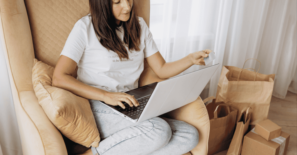 Woman shopping online with a laptop and credit card