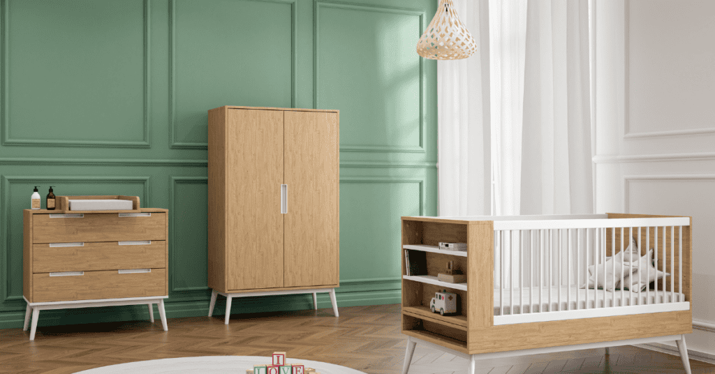 Nursery with wood crib, dresser, and wardrobe in a softly lit room