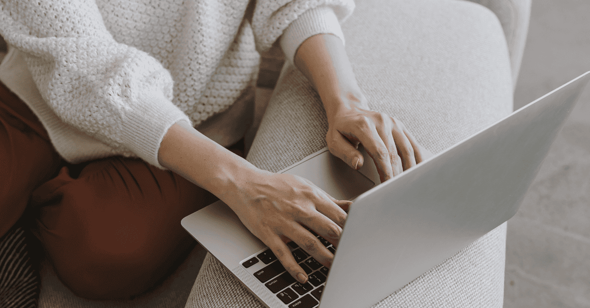 a woman typing on a laptop- indicating they are shopping online