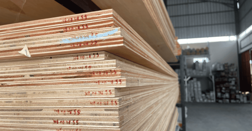 Close-up of stacked plywood sheets showing layered wood edges.