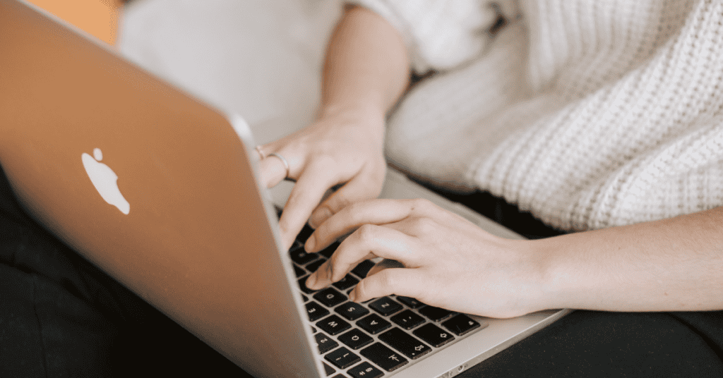 Person researching mattress materials and product details on a laptop.