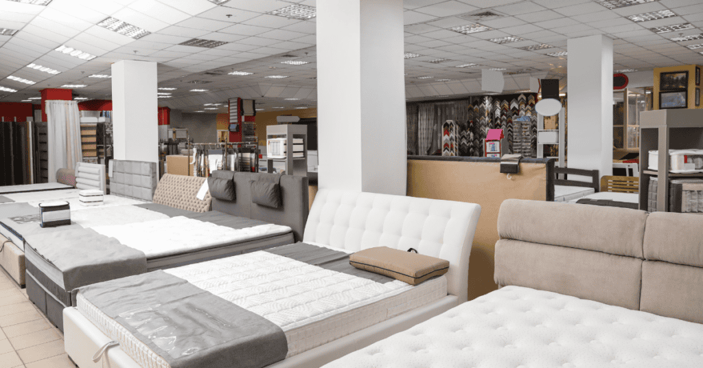 Mattress showroom with several bed styles on display for shoppers comparing options.