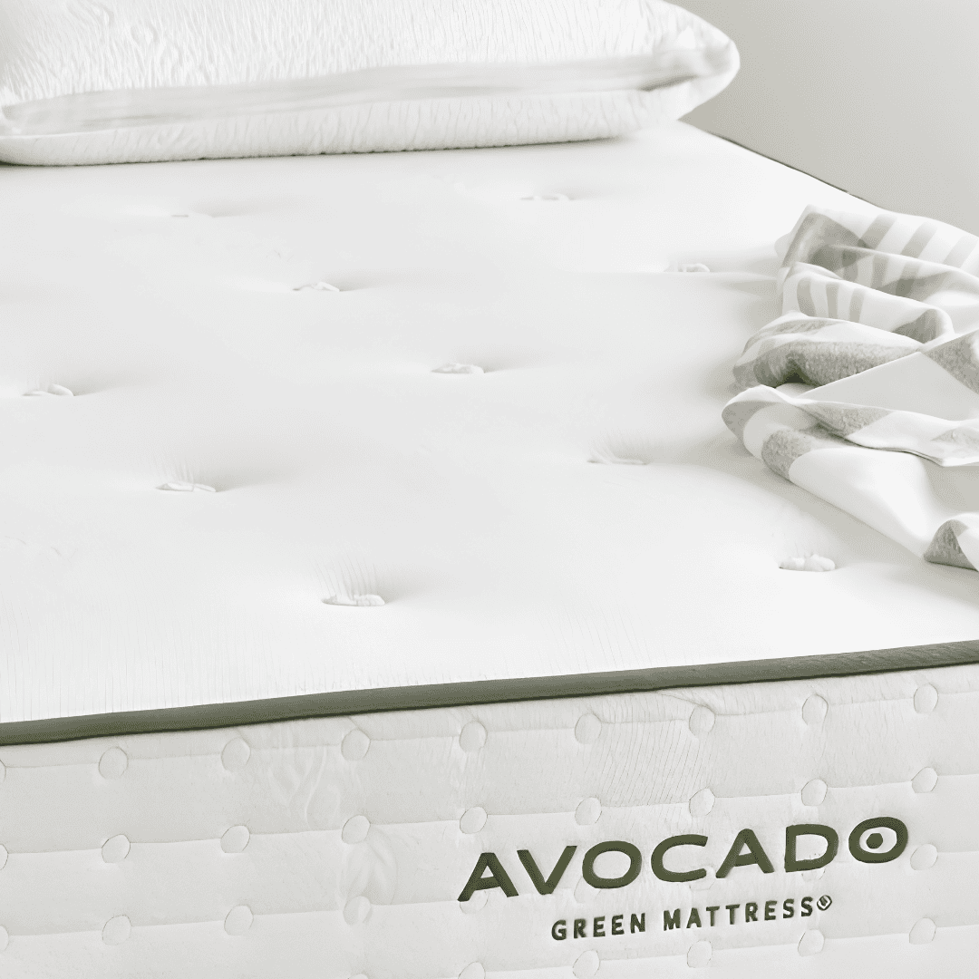Close-up of an Avocado Green Mattress with white tufted surface and green trim.