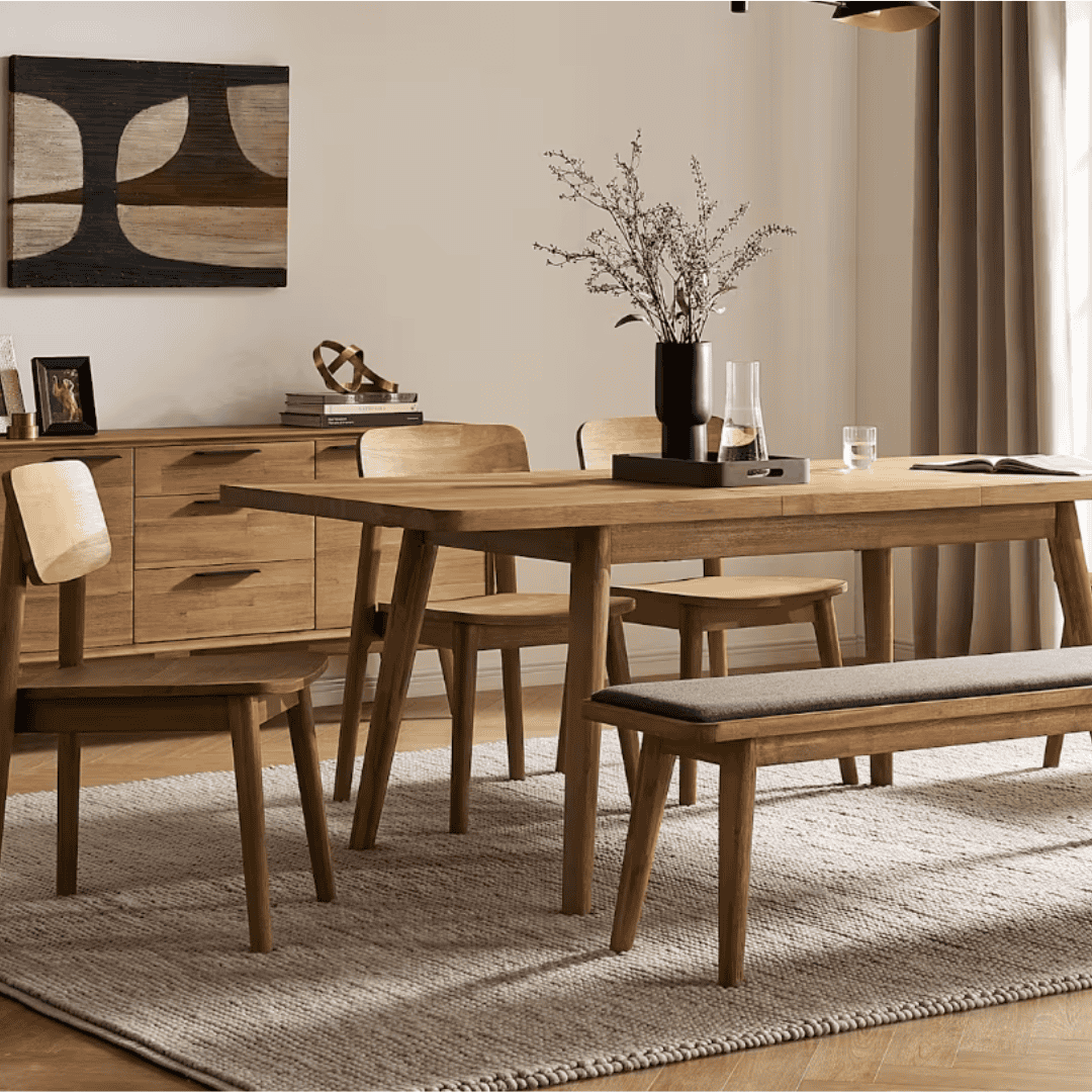 Wooden dining table, chairs, and upholstered bench in a modern dining room.