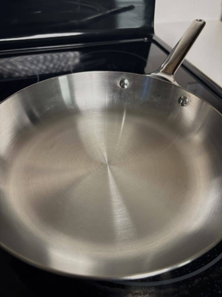 Caraway stainless steel frying pan with a shiny cooking surface after vinegar cleaning
